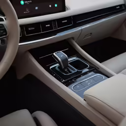 the front dashboard of a car with a blue phone in it
