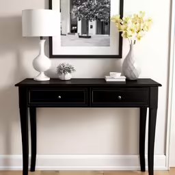 a black table with two white vases on top