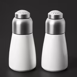 two salt and pepper mill shakers on a black table