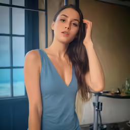a beautiful woman standing next to a window