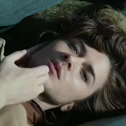 a man laying down next to a pillow