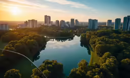 the city skyline at sunrise along a river with skyscrapers in the distance