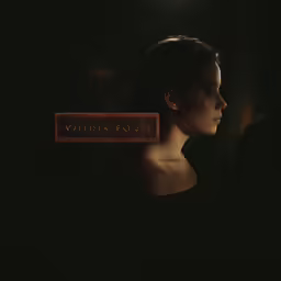 a woman in a dark room with a brick sign on her head