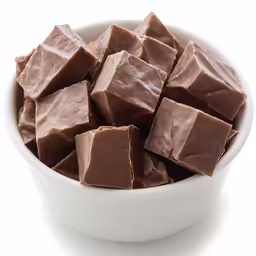 small bowl of chocolate squares in a white cup
