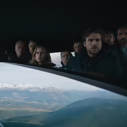 a group of people are sitting in the back of an airplane