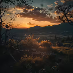 the sun is setting behind some hills