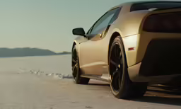 the rear end of a car on a dirt road