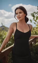 a woman in a black dress is posing on the deck