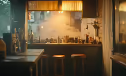 a kitchen with some stools at the counter