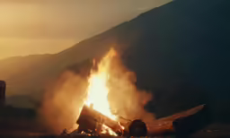 a bonfire that is burning in the grass