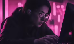 a woman wearing headphones using a computer