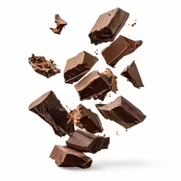 chocolate pieces flying into the air, one being split in half