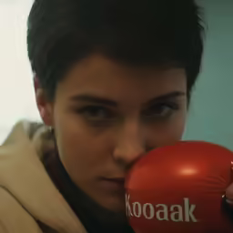 the woman in brown jacket has a red boxing glove