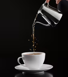 someone pouring coffee into a cup
