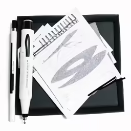a notepad is next to a marker, pen and other items