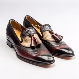 the black and brown broccoli are on top of the leather,this is a shoe for a man that is wearing it