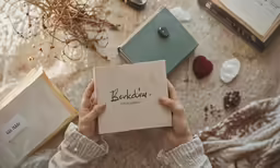 a person holding a card and book with an article in it