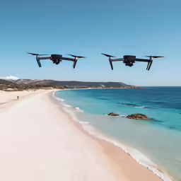 two remote controlled airplanes flying low above the ocean