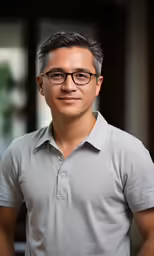 the man has glasses on and is standing near an open door