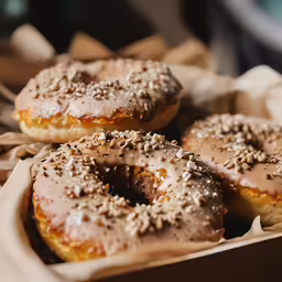 a close up of a box of doughnuts covered in icing