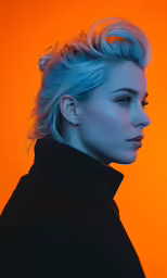 a woman with blue hair and black jacket on