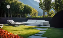 a white outdoor couch on a green lawn