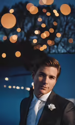 a man wearing a suit and standing next to a window