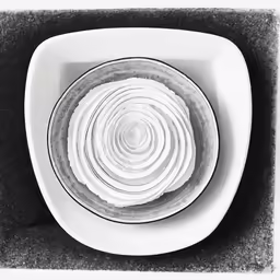 a white bowl filled with empty white plates