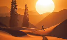 a man is walking up the hill with a sunset in the background