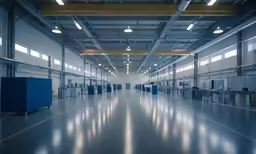an empty factory with lots of steel doors