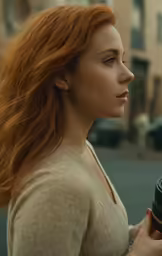 the redhead haired woman stands in front of a busy city street