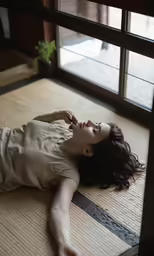the woman lays down on her belly on a tatami mat