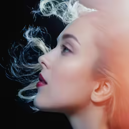 a woman with her hair blowing in the wind