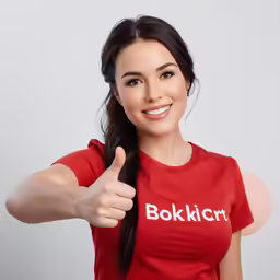a woman making a thumbs up while wearing a bokkick shirt