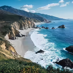 the view down on a beach with an ocean in the distance