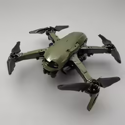 a toy green airplane with black propellers sitting on top of it