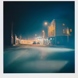 a town street with a lot of buildings and street lights