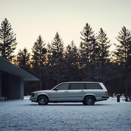 a white van is parked near a building and trees
