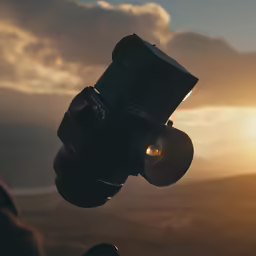 the camera is being held with the lens pointed towards the sunset