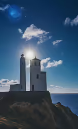 three white lighthouses are silhouetted against a cloudy blue sky