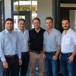 five men posing for a group photograph together