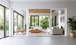 a living room filled with furniture and windows