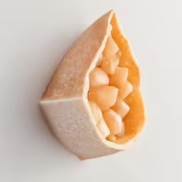 a peeled orange sitting inside of a piece of paper