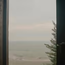 a view out of a window onto a body of water