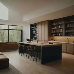 a kitchen that has a couch and a desk in it