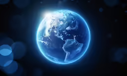 the earth is shown glowing against a dark background