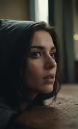 a beautiful woman laying on the ground in a living room