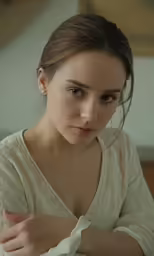 a woman with her hand resting on her arm