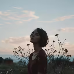a person in a field with a plant