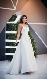 a woman standing in front of a white stage